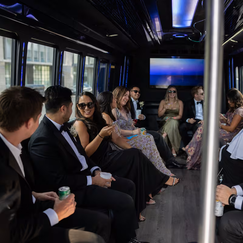 Wedding guests seated inside a Washington party bus