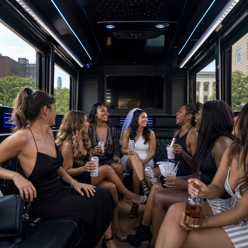 Party bus interior with wraparound leather seating and LED lighting in Washington