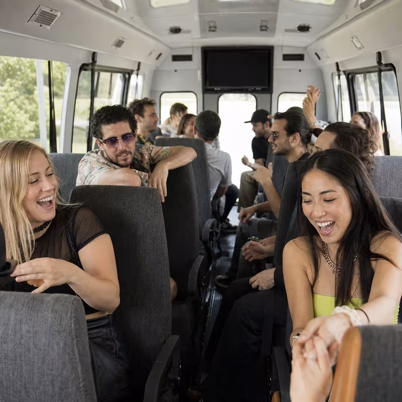 Party bus interior with wraparound leather seating and LED lighting in Washington