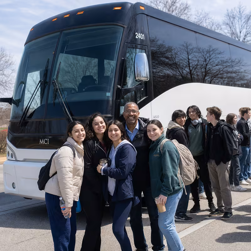 Passengers loading luggage while boarding an Washington group shuttle
