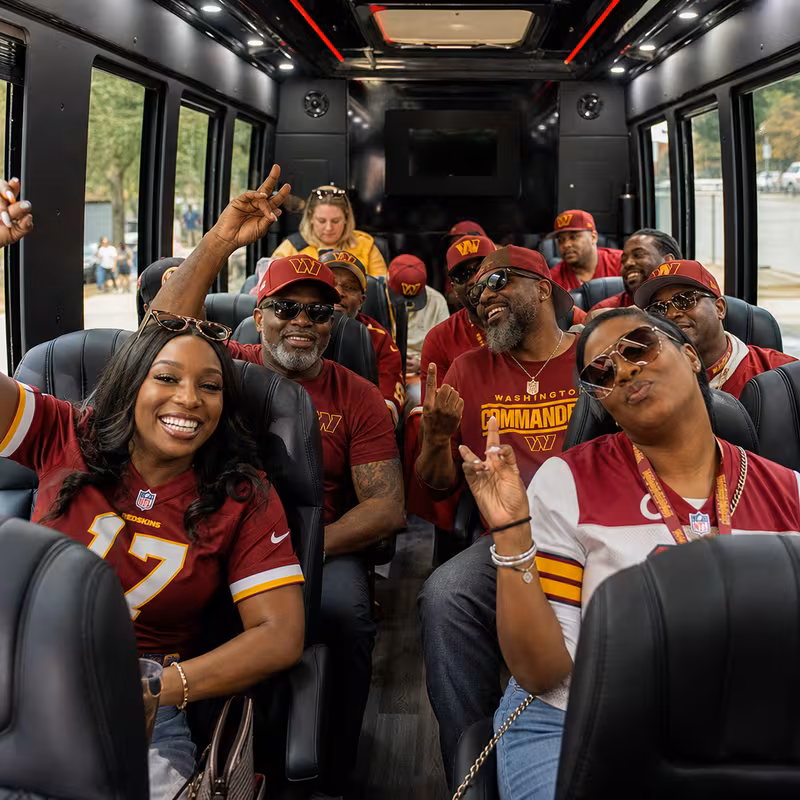 Group boarding a white charter bus for Sporting Event Transportation transportation in Washington