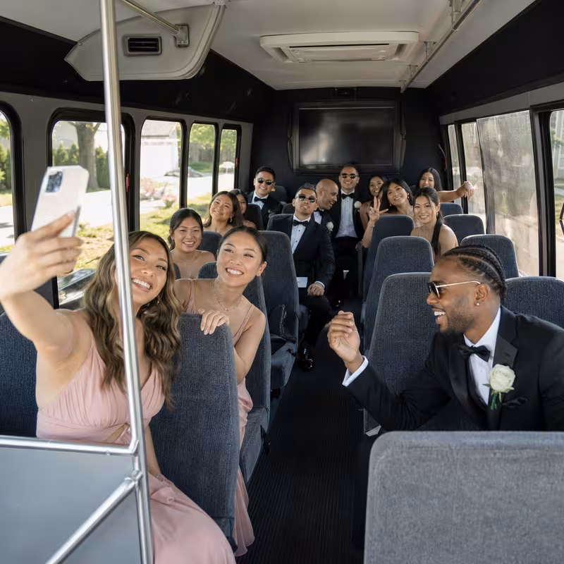 Group boarding a white charter bus for Wedding Transportation transportation in Washington