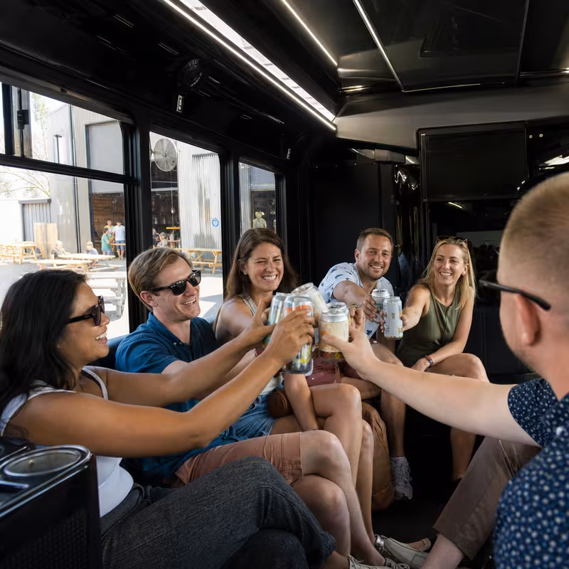 Group boarding a white charter bus for Winery & Brewery Tour Transportation transportation in Washington