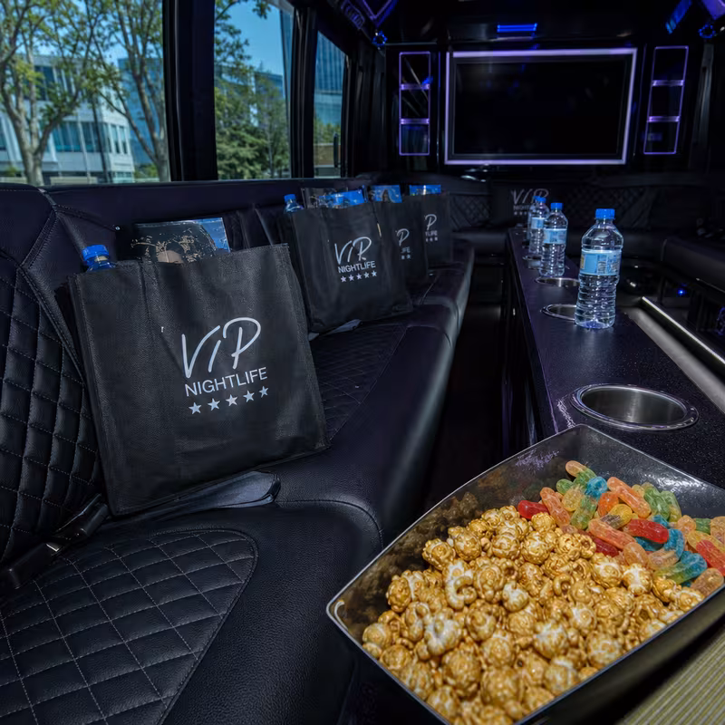 Party bus interior with wraparound leather seating and LED lighting in Washington